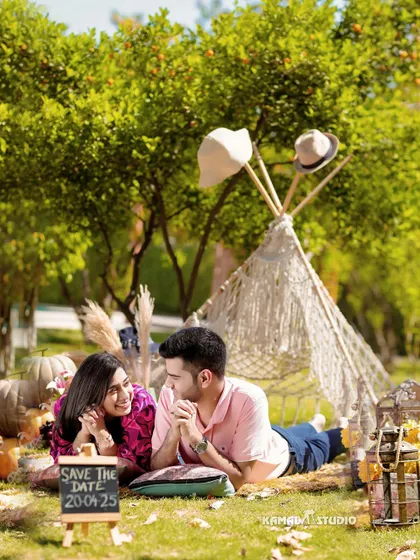 A cozy, themed picnic setup complete with a 'Save the Date' sign. We love incorporating personal details and creative concepts to make your pre-wedding shoot a fun, memorable experience that reflects your personality.