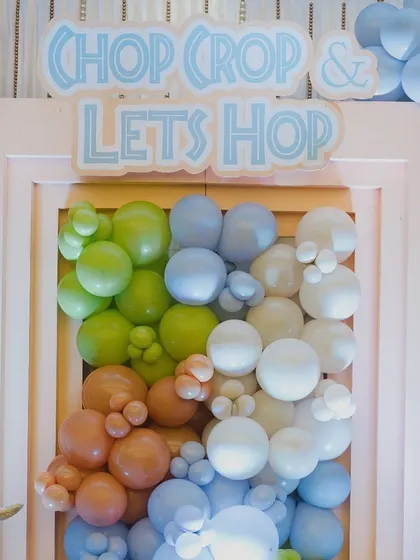 The 'Chop Crop & Let's Hop' sign and balloon detail from the Mundan ceremony backdrop.