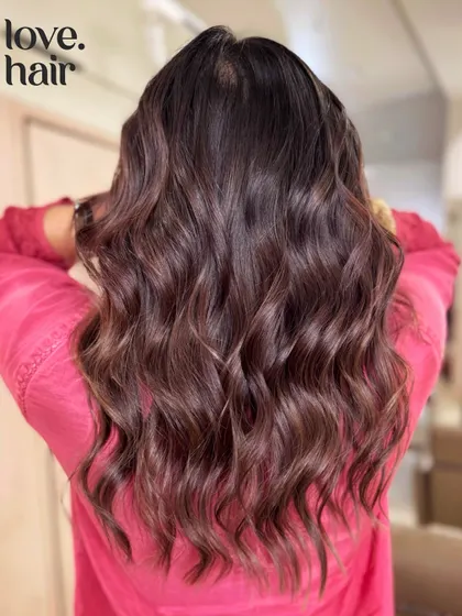 The back view of this multi-tonal brunette balayage, showing off the long, healthy waves.