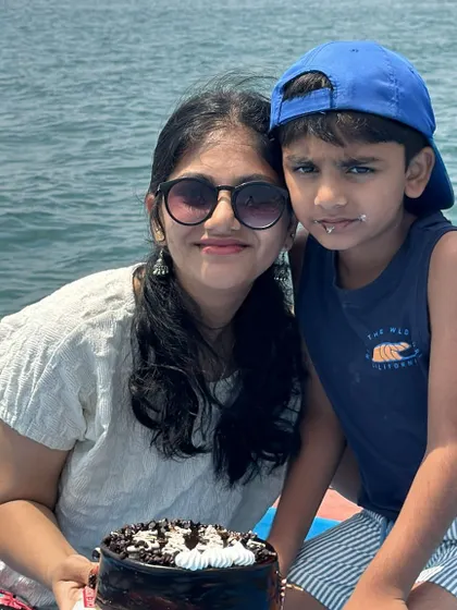 A mother and son celebrating with a cake during their private boat ride. We can accommodate celebrations for the whole family out on the water.