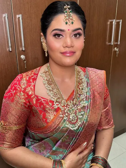 A close-up of the Pellikuthuru makeup, highlighting the pink tones on the eyes and lips.