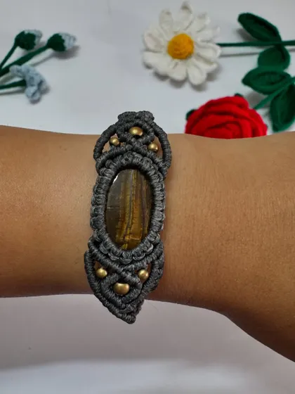This is my men's macrame bracelet with a Tiger's Eye stone. The dark grey cord and intricate knot work create a strong, masculine design.