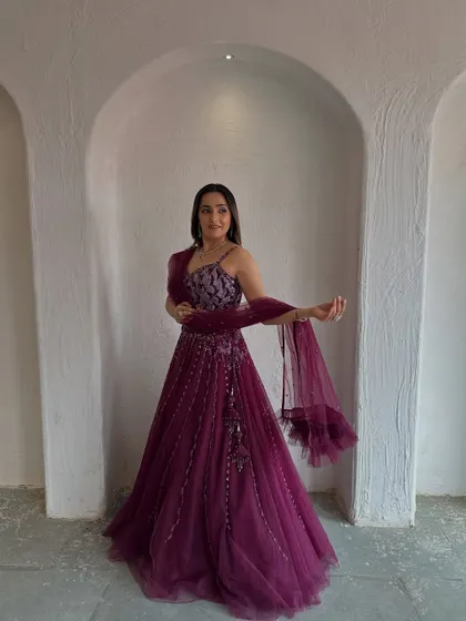 The full view of this gorgeous wine-colored lehenga. The flowing net skirt and embellished blouse create a beautiful silhouette.