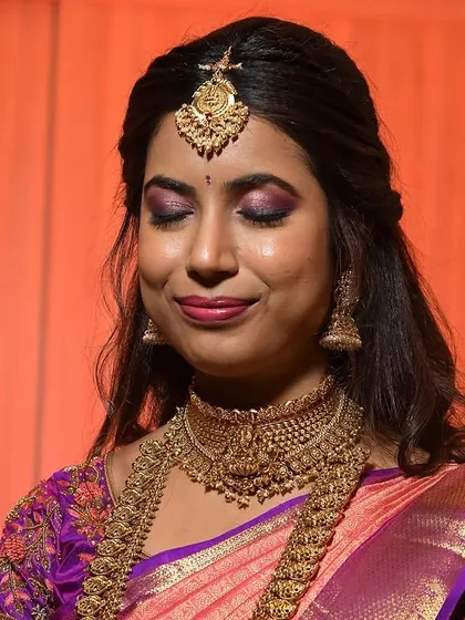 Santoshi's eyes are closed, showing off the full effect of the stunning purple and pink eyeshadow blend.