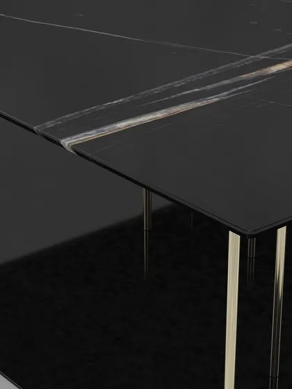 A close-up of the black marble top, showing the beautiful natural veining and the clean, sharp edges of this contemporary center table.