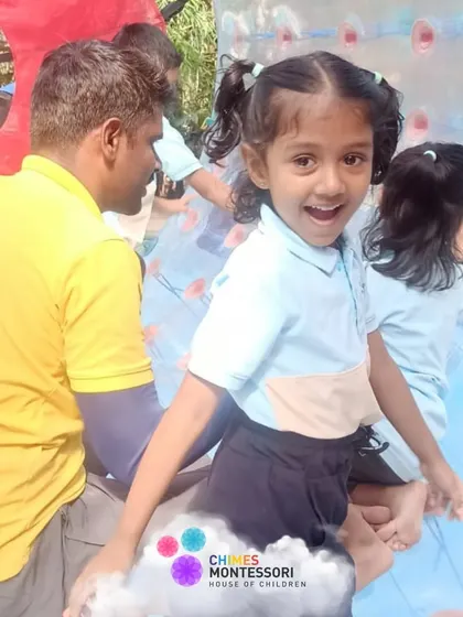 A child's face is full of pure joy as she gets ready to try zorb balling, a highlight of our adventurous field trip.