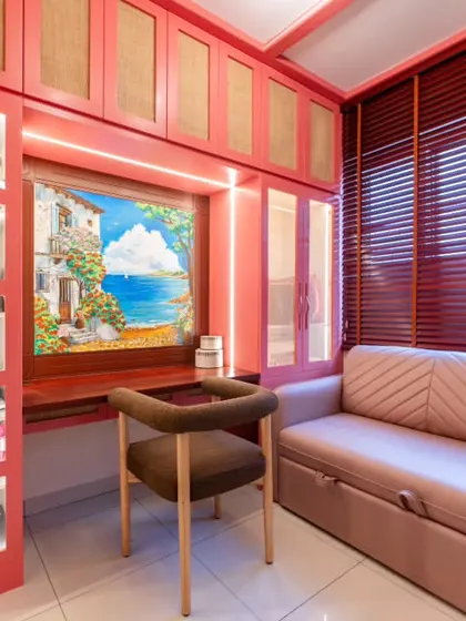 This multifunctional guest room features a hand-painted mural of a coastal village, turning a simple wall into a window to another world. The artwork serves as the focal point for the built-in desk area, making work feel like a mini escape.