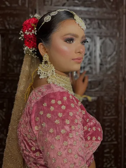 A beautiful shot of the bride, showcasing the complete look with her dupatta. The makeup is designed to be stunning from every angle.