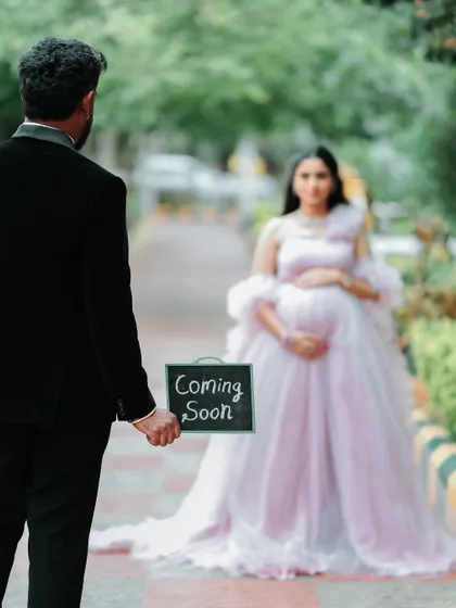 "Coming Soon". This creative shot perfectly captures the anticipation. The focus on the sign with the beautiful mom-to-be in the background tells a sweet story.