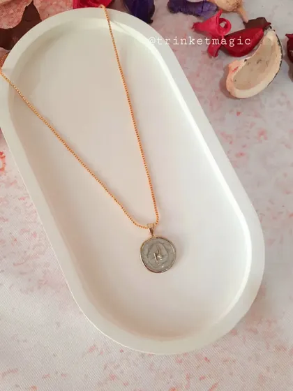 This celestial necklace features a star inside a white enamel pendant, perfect for those who love starry, cosmic-inspired jewelry.
