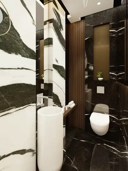 Another angle of the bespoke powder washroom, showcasing the bold interplay of different marbles. The design thoughtfully places mirrors to enhance the sense of space and reflect the rich patterns of the stone.