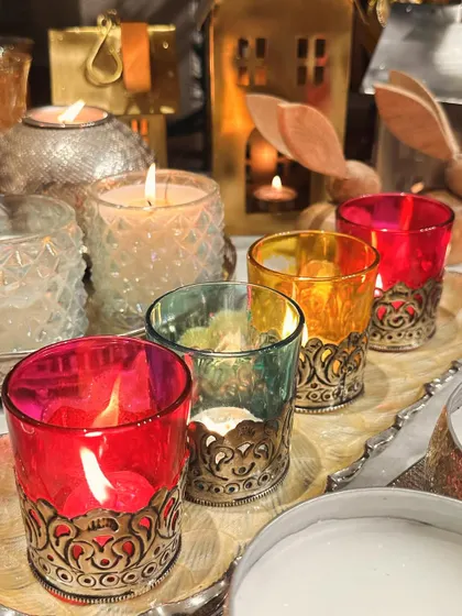 The warm glow of candles is essential for Christmas. Here are our colourful glass votives with intricate metal bases, perfect for adding a festive sparkle.