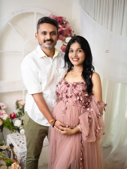 A classic and lovely portrait of the expecting couple. Their happy smiles and comfortable pose make for a timeless keepsake.