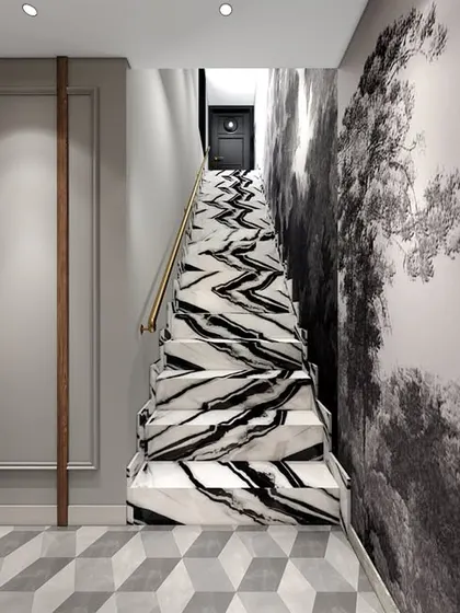A view of the waiting area's unique staircase, cladded in a dynamic black and white marble. This feature, combined with the mural and geometric flooring, creates a powerful design statement.