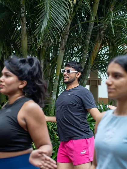 Participants fully engaged in an outdoor wellness session. Moving together in the fresh air adds an extra layer of vitality to the experience.