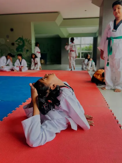 Another student demonstrating a graceful and deep backbend on the mat.
