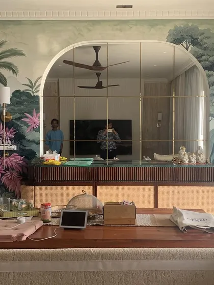 A wall mural can completely redefine a room. This wide view shows the scale of our nature mural, demonstrating how it integrates with the arched mirror and furniture to create a fully immersive, artistic atmosphere.