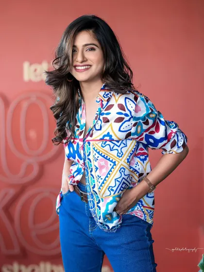 A lifestyle fashion shoot for an actress, featuring a colorful printed shirt and blue jeans. Shot in a modern cafe, these images have a bright, energetic, and youthful feel, perfect for a commercial or social media campaign.