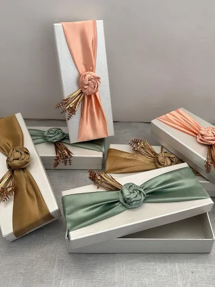 These elegant gift boxes with satin floral wraps are part of my custom curation service. I can create them in any color to perfectly match your wedding or event theme.