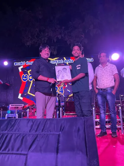 Presenting a framed portrait to a respected dignitary on stage during a public event. It is an honor to have my art be part of such important occasions.