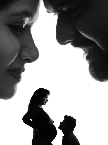 A creative double-exposure style silhouette, combining a close-up of the couple's faces with a full-body silhouette.