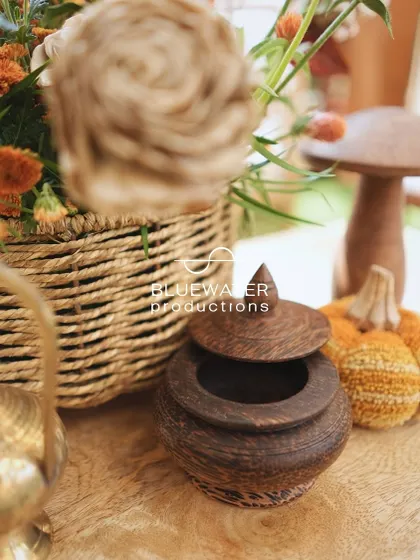 A collection of small wooden props and woven baskets adds to the earthy, handcrafted feel of the decor.