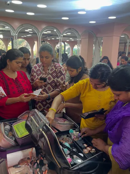 A closer look at students getting hands-on with a professional makeup kit. They learn to organize their tools and products for efficient work.