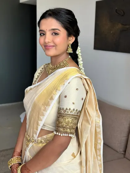 A portrait of my beautiful South Indian bride. Her makeup is fresh and radiant, with a soft rosy blush that complements the gold of her Kasavu saree.