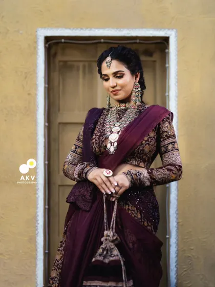 A final portrait from the "Threads of Tradition" series. The rich colors of the outfit are balanced with a sophisticated and timeless makeup look.