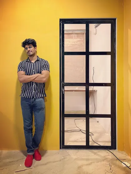 A first look at a photography and dance studio we designed. The bold yellow wall creates an energetic backdrop, while the black-framed retro door adds a touch of industrial chic.