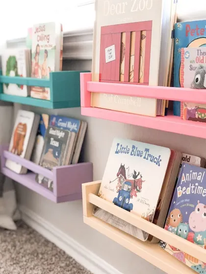 Add a pop of color with these simple, wall-mounted book ledges. Painted with non-toxic colors, they are a safe and cheerful way to create a mini library on any wall.