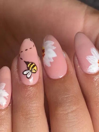 Bee-autiful, isn't it? A sweet little hand-painted bee buzzing towards daisies on a lovely pink base. This is what delicate, custom nail art is all about.