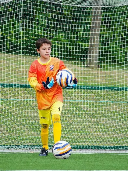 A young goalkeeper ready for action during a U13 training session as the team prepares for the KSFA youth premier league.