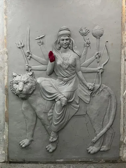 The full clay model of the Maa Durga mural, showing the goddess seated on her tiger. This is the master sculpture from which a lightweight and durable fiber cast is made.