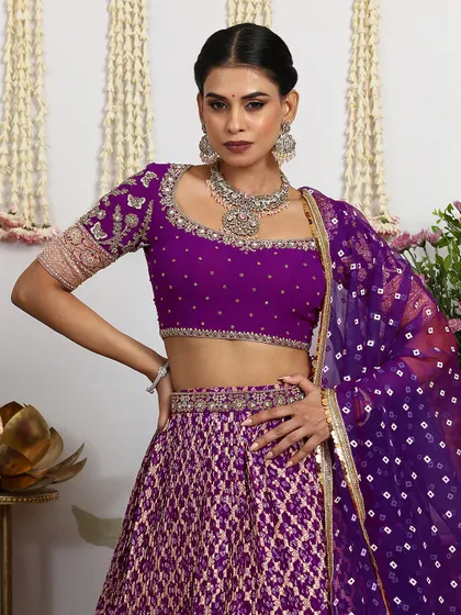 A close-up of the short-sleeved blouse, highlighting the intricate embroidery and the beautiful Bandhani dupatta.