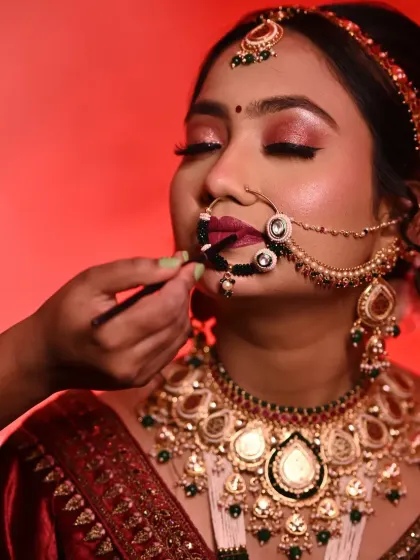 The final touch. Applying the lipstick is the last step that brings the whole look together. Here, I'm using a brush for a precise application of a deep berry shade.