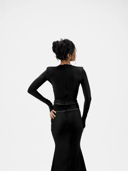 A view of the messy updo from the back. This shows the structure and artistry of the hairstyle, which is designed to look effortlessly chic from all angles.