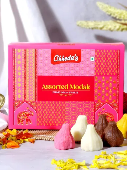 For this assorted modak box, I used a vibrant pink background and scattered flower petals to create a rich, festive look. The shot showcases the colorful variety of the sweets, perfect for the Ganesh Chaturthi festival.