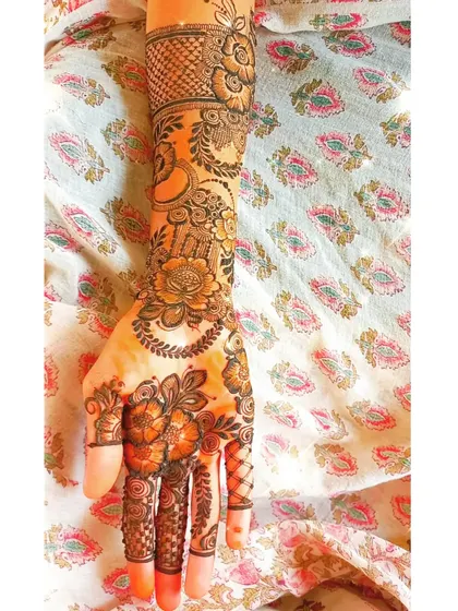 A full arm design with a mix of florals, paisleys, and geometric patterns.
