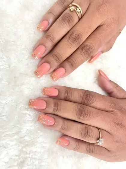 I love how minimalistic yet glamorous these bridal nails are. This set features a soft peach color with a gentle fade into gold glitter at the tips, creating a subtle ombre effect.