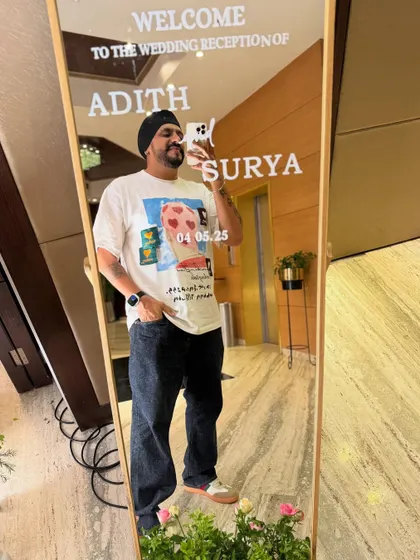 A mirror selfie at the entrance of a South Indian wedding reception for Adith and Surya. It's great to see the personalized welcome signs that set the tone for the celebration.