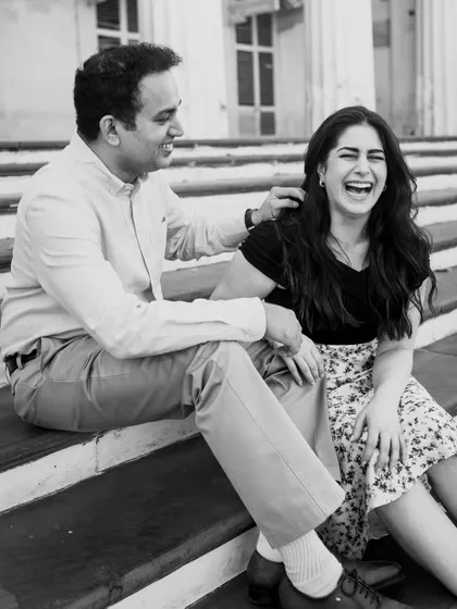 A moment of shared laughter on the steps of a heritage building. This candid black and white photo is a perfect example of the genuine joy I love to capture.