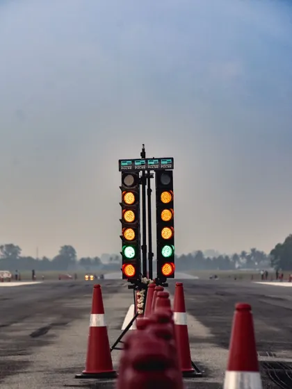 The Christmas tree lights go green, signaling the start of another explosive race. This iconic image captures the tense, split-second moment before the launch.
