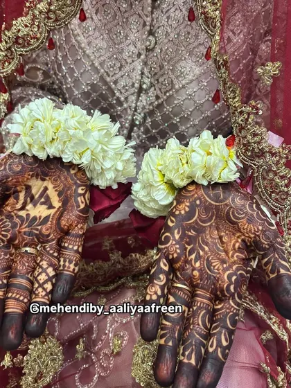 The final look for a beautiful bride, with her dark mehendi stain complemented by floral jewelry.