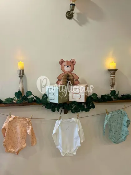 Adorable details from a baby shower, including 'BABY' blocks, tiny clothes on a line, and soft candlelight.