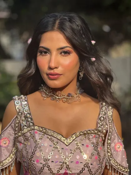 A lovely portrait capturing the soft glam makeup. The flushed cheeks and pink eyeshadow give her a fresh and youthful glow.