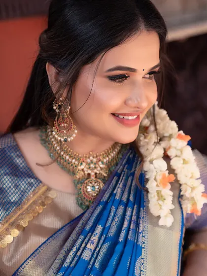A close-up of my look for 'Navataara' Day 4. I paired the blue saree with traditional gold jewelry and jasmine flowers in my hair.