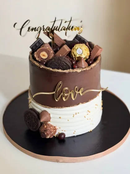 Layers of love and swirls of sweetness to say congratulations. This decadent chocolate overload cake, topped with Ferrero Rocher and Oreos, is perfect for celebrating any big win.