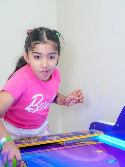 The look of intense concentration during an exciting game of air hockey.