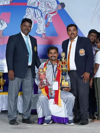 Being felicitated and honored at a karate championship event. I am grateful for the respect and recognition from the martial arts community.